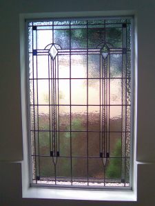 Art Deco stained glass with diamond bevels and blue glass